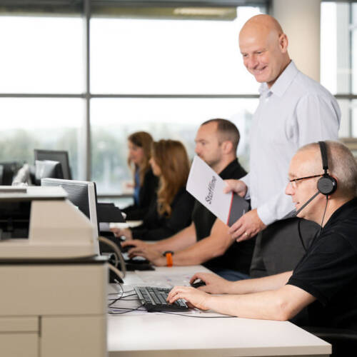 Staffline team member wearing headset and making calls
