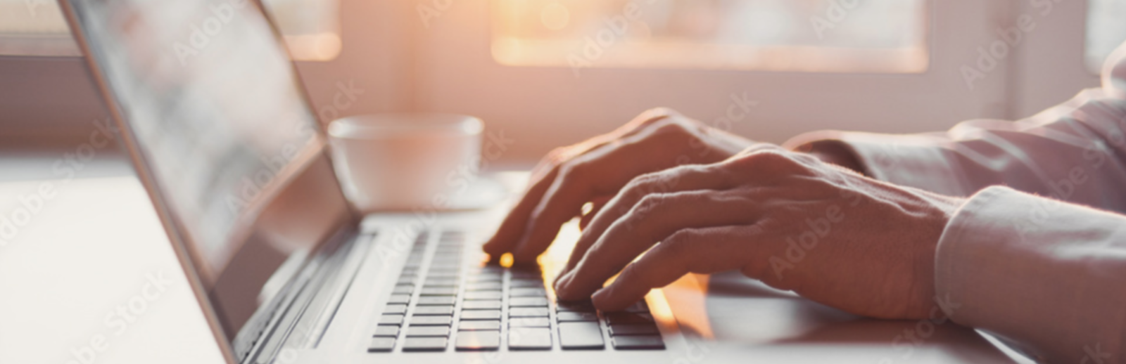 Person typing on laptop keyboard