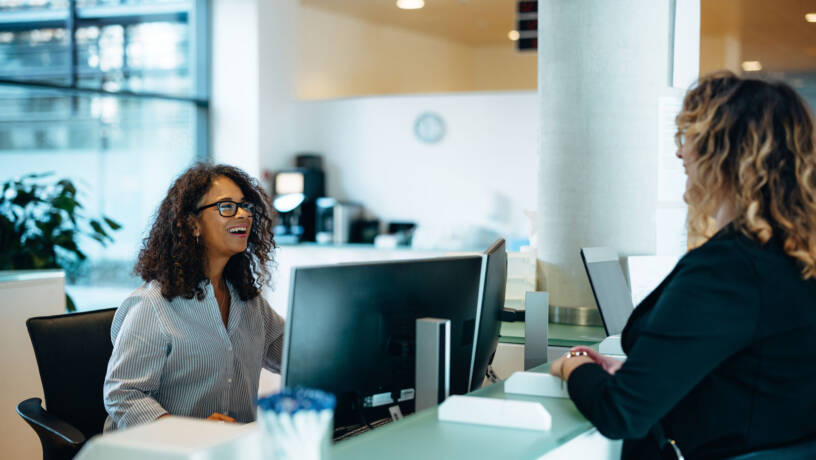 Administrative assistant chatting to customer
